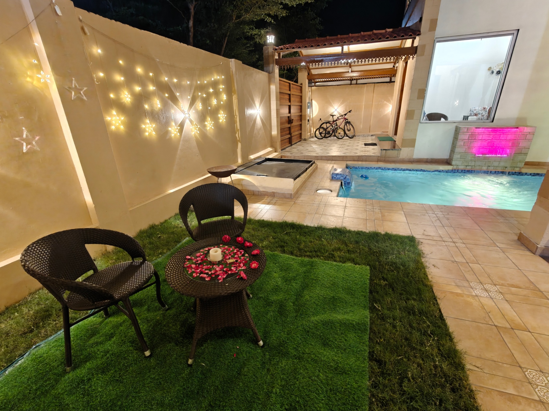 Poolside seating with garden lights and candles