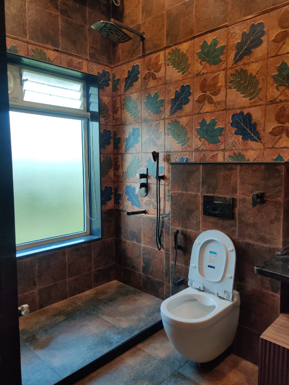 Rustic bathroom with hand-painted leaf-motif tiles