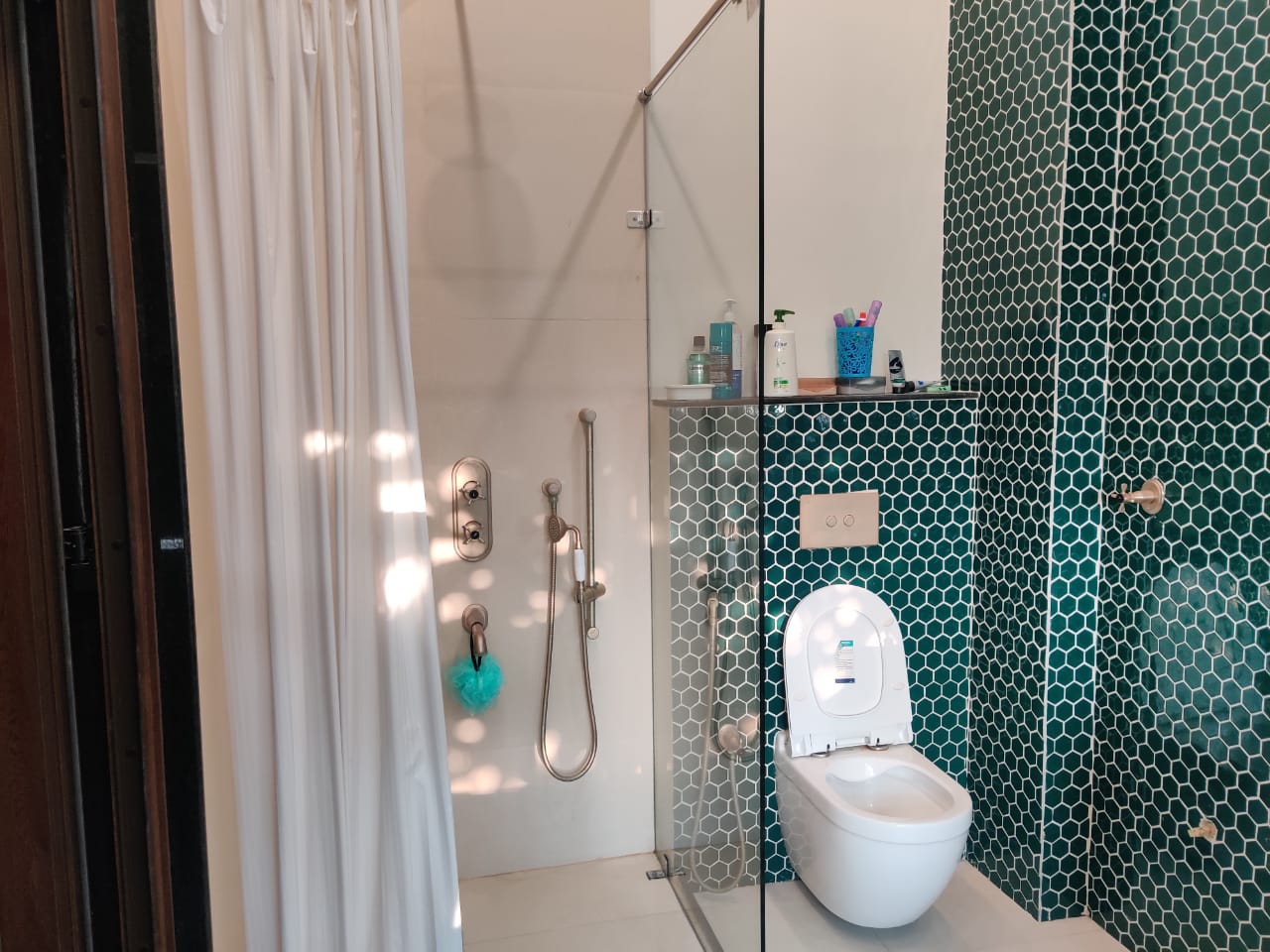 Modern bathroom with emerald green hexagonal mosaic tiles