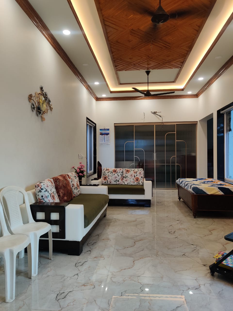 Spacious living room with wooden ceiling and marble flooring