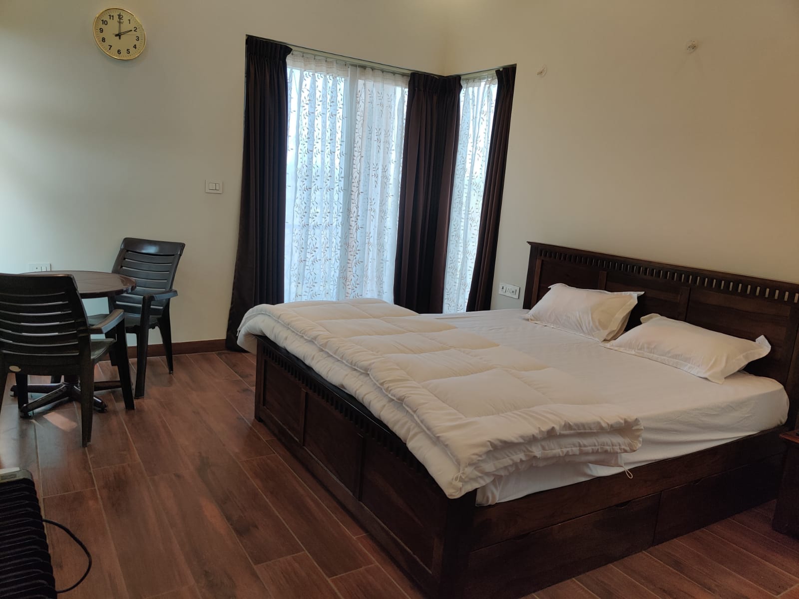 Bedroom suite with seating area and garden views